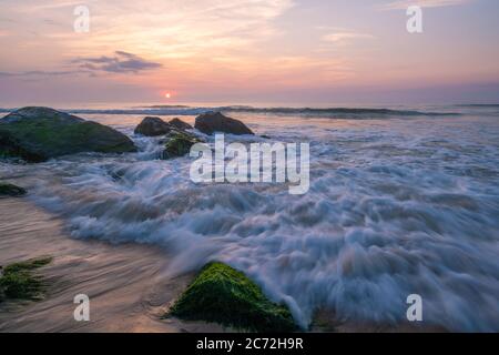 Dreamy peaceful sunrise over Jersey Shore after she storm featuring beautiful waves on the foreground Stock Photo