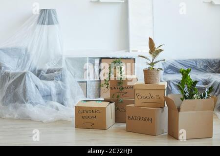Image of signed cardboard boxes on the floor in the new apartment Stock Photo