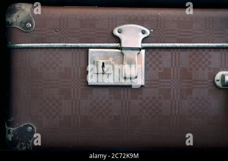 The keyhole is on an old closed suitcase. Retro-style Stock Photo