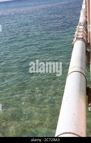 Long steel pipe fastened to  cruise pier Stock Photo