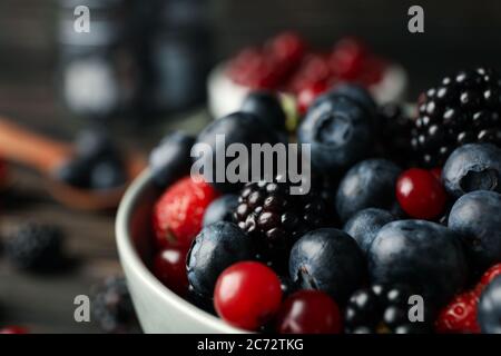 Composition with bowl of fresh berries, close up Stock Photo