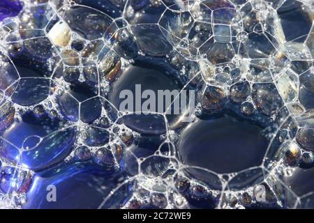 Bubbles on top of blue water with texture an macro close up. Stock Photo