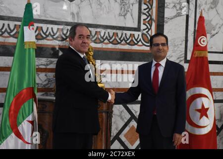 Tunis, Tunisia. 13th July, 2020. Tunisian Foreign Minister Noureddine Erray (R) shakes hands with Algerian Foreign Minister Sabri Boukadoum during their meeting in Tunis, Tunisia, on July 13, 2020. Credit: Adel Ezzine/Xinhua/Alamy Live News Stock Photo