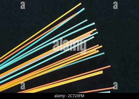 Close up macro of a colorful group of  fiber optics on a black background. Stock Photo