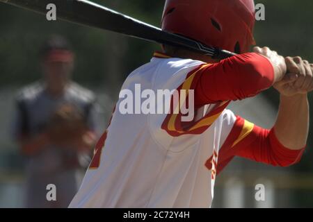 A baseball batter waits for the pitcher to throw the ball. Stock Photo