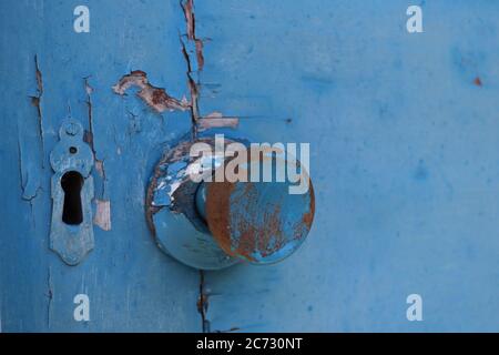 Old blue door, close up of doorknob and key hole  Stock Photo