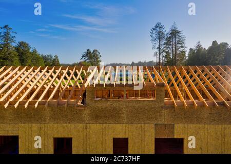 Roof beams of unfinished new home under construction. Stock Photo