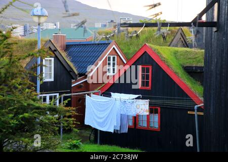 Laundry hanging outside of a traditional turf roof house in Old Town (Tinganes) of Torshavn.Streymoy.Faroe Islands.Territory of Denmark Stock Photo