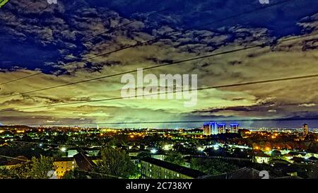 Glasgow, Scotland, UK 14th July, 2020: UK Weather: Midnight rainstorm travelled over western sky of  the city producing an unusual mushroom picture under the street lights that would not be visible during the day of the city. Credit: Gerard Ferry/Alamy Live News Stock Photo