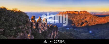 Landscape panorama of Australian Blue Mountains with Three Sisters rock formation at sunrise. Stock Photo