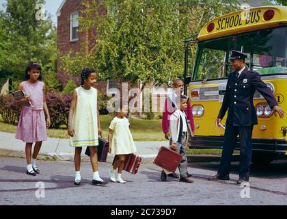 1960s FIVE AFRICAN-AMERICAN KIDS BOYS AND GIRLS CROSSING STREET BY SCHOOL BUS WITH AFRICAN-AMERICAN POLICEMAN DIRECTING TRAFFIC - ks3125 HAR001 HARS NOSTALGIA CROSSING OLD FASHION 1 POLICEMAN JUVENILE ELEMENTARY CAREER SECURITY BALANCE SAFETY PUBLIC TEAMWORK LIFESTYLE SATISFACTION FIVE FEMALES 5 JOBS HEALTHINESS COPY SPACE FULL-LENGTH PERSONS CARING MALES RISK OFFICER PROFESSION CONFIDENCE TRANSPORTATION COP PROTECT AND SERVE SCHOOLS WIDE ANGLE SKILL GRADE OCCUPATION HAPPINESS SKILLS PROTECTION STRENGTH MOTOR VEHICLE AFRICAN-AMERICANS COURAGE AFRICAN-AMERICAN AND CAREERS KNOWLEDGE POWERFUL Stock Photo
