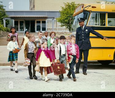 1960s GROUP OF ETHNICALLY DIVERSE ELEMENTARY STUDENTS AFTER SCHOOL CROSSING THE STREET PROTECTED BY AFRICAN-AMERICAN POLICEMAN - ks3121 HAR001 HARS OLD TIME BUSY FUTURE NOSTALGIA CROSSING OLD FASHION 1 POLICEMAN JUVENILE ELEMENTARY DIVERSE CAREER SECURITY BALANCE SAFETY PUBLIC TEAMWORK LIFESTYLE SATISFACTION ARCHITECTURE FEMALES JOBS COPY SPACE FULL-LENGTH PERSONS INSPIRATION CARING MALES RISK OFFICER BUILDINGS PROFESSION CONFIDENCE TRANSPORTATION AFTER COP PROTECT AND SERVE SCHOOLS SUCCESS WIDE ANGLE SKILL GRADE OCCUPATION HAPPINESS SKILLS PROTECTION STRENGTH MOTOR VEHICLE AFRICAN-AMERICANS Stock Photo