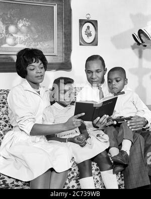 1960s AFRICAN-AMERICAN FAMILY SITTING ON COUCH READING THE BIBLE TOGETHER - n1836 HAR001 HARS INDOORS NOSTALGIC PAIR 4 MOTHERS BIBLE OLD TIME NOSTALGIA BROTHER READ OLD FASHION SISTER 1 JUVENILE COUCH STYLE COMMUNICATION INFORMATION SONS FAMILIES JOY LIFESTYLE RELIGION FEMALES MARRIED BROTHERS SPOUSE HUSBANDS HEALTHINESS HOME LIFE COPY SPACE FRIENDSHIP HALF-LENGTH LADIES DAUGHTERS PERSONS INSPIRATION MALES CHRISTIAN SIBLINGS SPIRITUALITY SISTERS FATHERS B&W PARTNER HAPPINESS RELIGIOUS AFRICAN-AMERICANS AFRICAN-AMERICAN CHRISTIANITY DADS BLACK ETHNICITY SIBLING CONNECTION HOLY STYLISH FAITHFUL Stock Photo