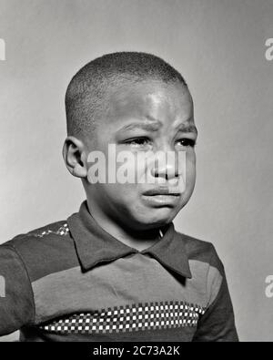 1940s 1950s PORTRAIT OF SAD YOUNG AFRICAN-AMERICAN BOY ABOUT TO BEGIN CRYING - n588 HAR001 HARS MALES ABOUT EXPRESSIONS TROUBLED B&W CONCERNED SADNESS WEEPING HEAD AND SHOULDERS AFRICAN-AMERICANS AFRICAN-AMERICAN BLACK ETHNICITY BAWLING BEGIN OF TO MOOD SOBBING CONCEPTUAL GLUM GROWTH JUVENILES MISERABLE BLACK AND WHITE HAR001 OLD FASHIONED AFRICAN AMERICANS Stock Photo