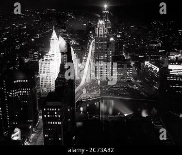 1960s NIGHT SCENE OF MICHIGAN AVENUE FROM PRUDENTIAL BUILDING WITH ILLUMINATED WRIGLEY BUILDING AND TRIBUNE TOWER CHICAGO USA  - r6400 HAR001 HARS CITIES EDIFICE CHICAGO RIVER ILLINOIS ILLUMINATED PRUDENTIAL TRIBUNE AERIAL VIEW BLACK AND WHITE HAR001 IL MICHIGAN AVENUE MIDWEST OLD FASHIONED WRIGLEY
