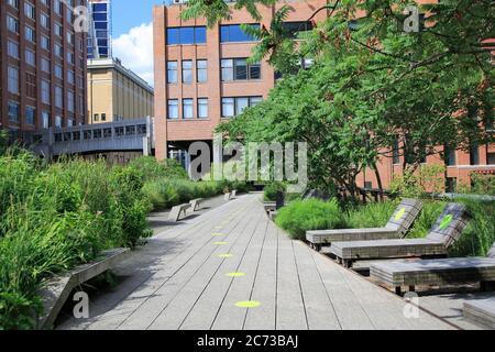 High Line Park in Manhattan reopens to the public July 16 with limited capacity, social distancing rules in place and requiring visitors to wear masks. Green circles on the walkways help visitors keep six feet apart. The park had been closed since March during the cornonavirus pandemic lockdown. New York City, USA July 2020 Stock Photo