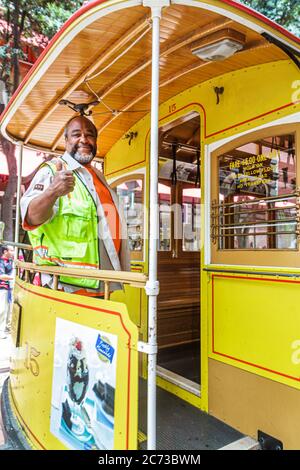 San Francisco California,Powell Street,Hallidie Plaza,downtown street scene,transit system,historic cable car,icon,conductor,Black man men male adult Stock Photo