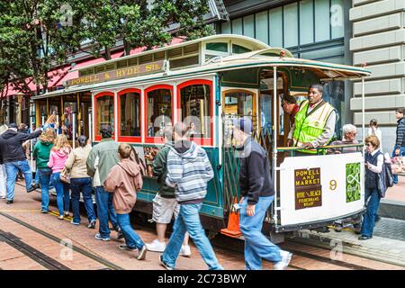 San Francisco California,Powell Street,Hallidie Plaza,downtown street scene,transit system,historic cable car,icon,man powered turntable,conductor,Bla Stock Photo