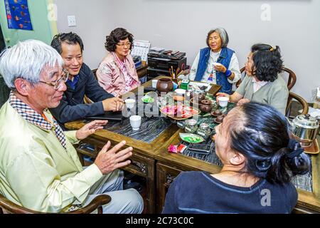 San Francisco California,Chinatown neighborhood,Grant Street,tearoom,tea house,cha guan,family families parent parents child children,Asian man men ma Stock Photo