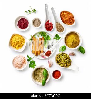 Different indian spices in a bowls and herbs on white background. Top view of indian spices with copy space. Stock Photo