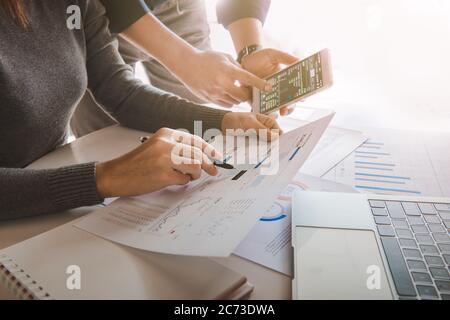 Business team analyzing sales data and economic growth graph chart on office table with laptop and smart phone, Brainstorming, Business strategy and p Stock Photo