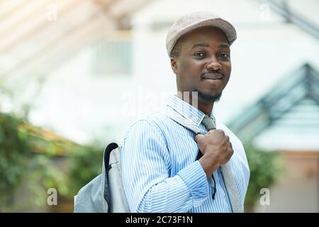 Portrait of African young businessman smiling at camera while standing outdoors Stock Photo