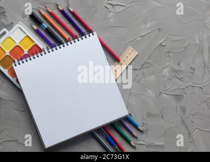School supplies center composition on grey .concrete background Stock Photo