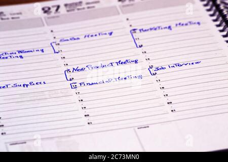scheduling meeting time on a notepad to fix a business meeting. concept for business, job applications Stock Photo