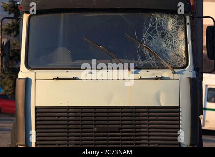 Broken windshield of a truck (lorry). Accident and traffic accident. The crash. A gunshot attack on a car. Abandoned truck after an accident Stock Photo