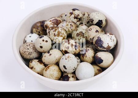 fresh quail eggs isolated on white background in a basket Stock Photo