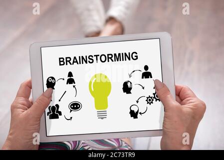 Brainstorming concept shown on a tablet held by a woman Stock Photo