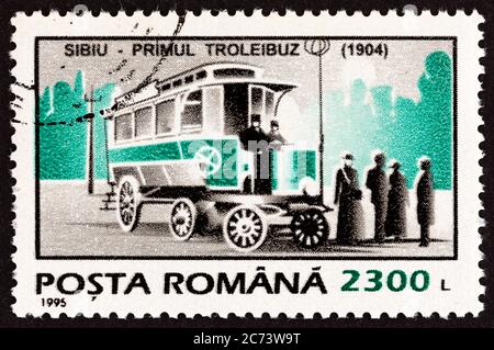 ROMANIA - CIRCA 1995: A stamp printed in Romania from the 'Means of Transport' issue shows the first trolleybus, 1904, Sibiu, circa 1995. Stock Photo