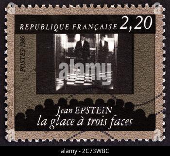 FRANCE - CIRCA 1986: A stamp printed in France shows Rene Ferte in The Triple Mirror dir. Jean Epstein, circa 1986. Stock Photo