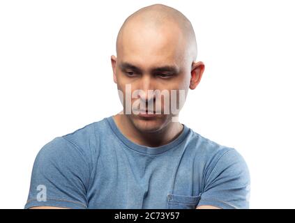 Photo of young bald puzzled man in tee shirt Stock Photo