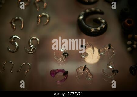 A display case of body piercing jewellery at a tattoo and body piercing parlour in Sydney, Australia. Stock Photo