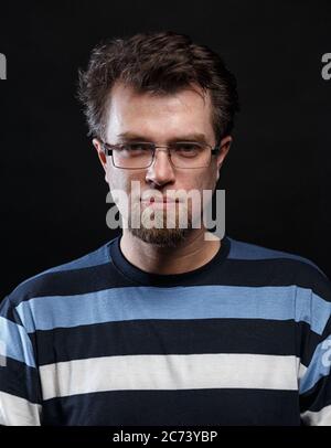 Portrait of smiling bearded young man in glasses Stock Photo