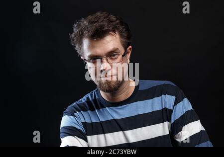 Young smiling bearded blond man in glasses Stock Photo