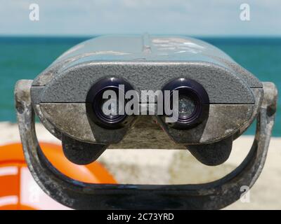 A pair of Binoculars looking out to Sea Stock Photo