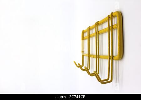 Yellow wall hanger isolated on a white background, close-up Stock Photo
