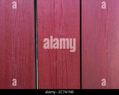 Red wood texture background. .Old ragged painted fence. Stock Photo