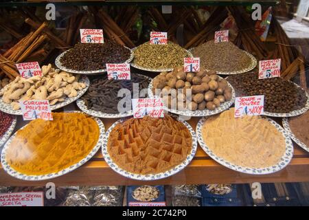 Spices of different colors placed on plates. They are spices like paprika, turmeric, ginger, cinnamon. Stock Photo