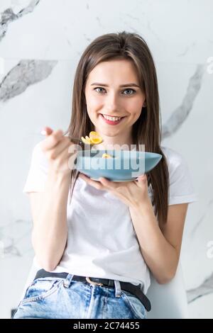 Young attractive girl at breakfast in modern kitchen Stock Photo