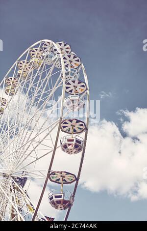 Retro toned picture of a Ferris wheel on a sunny day. Stock Photo