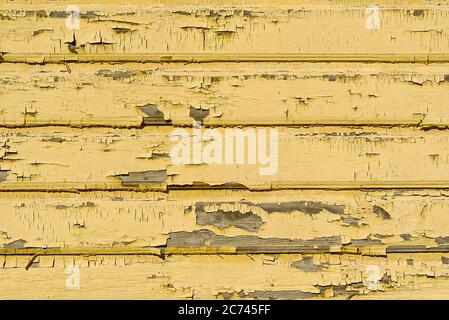 The texture of old scratched yellow wooden planks. Old painted wood wall texture. Stock Photo