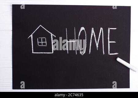 Black chalkboard with house and word home. Stock Photo