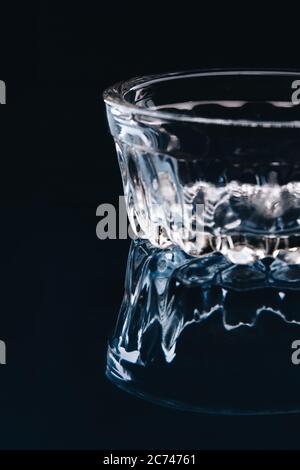 Small low glass bowl on black background. Stock Photo