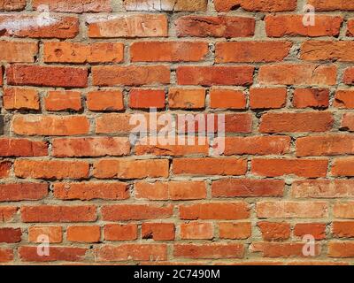 THE RED Weathered stained old brick wall. Stock Photo
