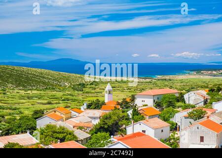 Old village of Kolan on the island of Pag in Dalmatia, Croatia, Adriatic seascape in background Stock Photo