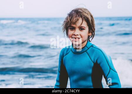 A young boy learning in body board outdoors in the shoreline in a sunny day of summer