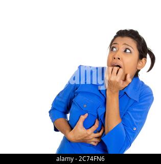 Portrait of a young woman looking scared and very anxious Stock Photo